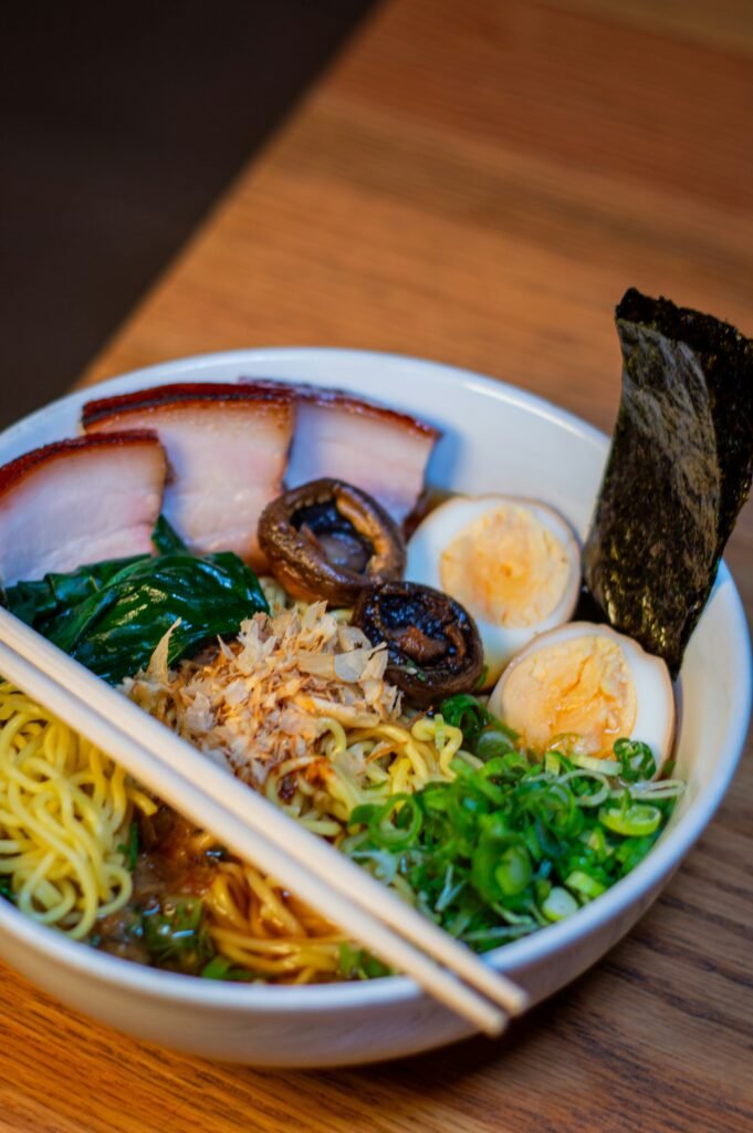 a bowl of food with chopsticks on a table